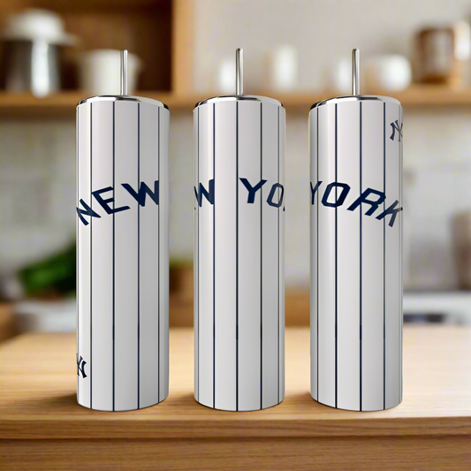 Three Kreative Kreationz New York Yankees 20oz Tumblers with vertical navy blue pinstripes and bold "NEW YORK" lettering are shown on a wooden kitchen countertop.