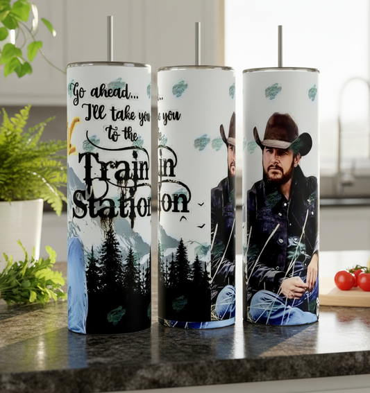 The Kreative Kreationz RIP Yellowstone 20oz Tumbler features a man in a cowboy hat, denim jacket, mountains, trees, and "Go ahead... I'll take you to the Train Station" for rustic, western-themed drinkware.