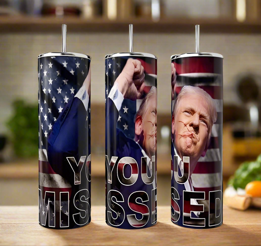 The Kreative Kreationz YOU MISSED 20oz Tumbler displays an American flag and a suited man making a fist, with "YOU MISSED" in bold. This insulated tumbler keeps drinks hot or cold.