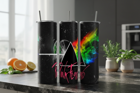 Three black tumblers with colorful designs and 'Pink Floyd' text on a kitchen counter.