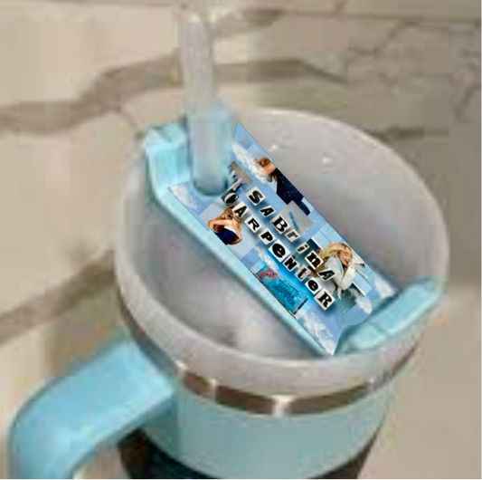 A blue and white Stanley tumbler with ice and a straw is topped with the Kreative Kreationz Sabrina Carpenter Expresso Collage Stanley Lid Topper, which features people posing on a light blue background.