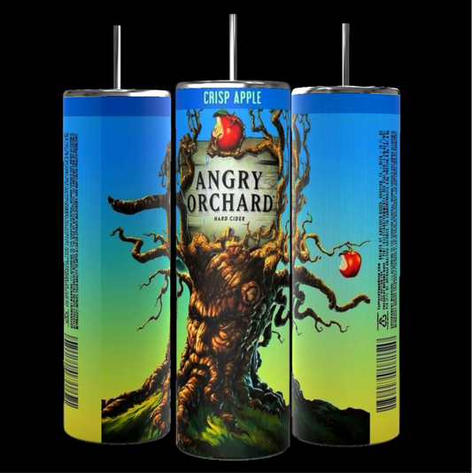 Three cans of Angry Orchard Crisp Apple Hard Cider are arranged with their labels showing. The central can features the Angry Orchard logo with an illustration of a gnarled tree with apples. The background is a blurred image of a sunny orchard, next to a Kreative Kreationz product: the Angry Orchard 20oz Tumbler boasting durable construction and 20 oz capacity.