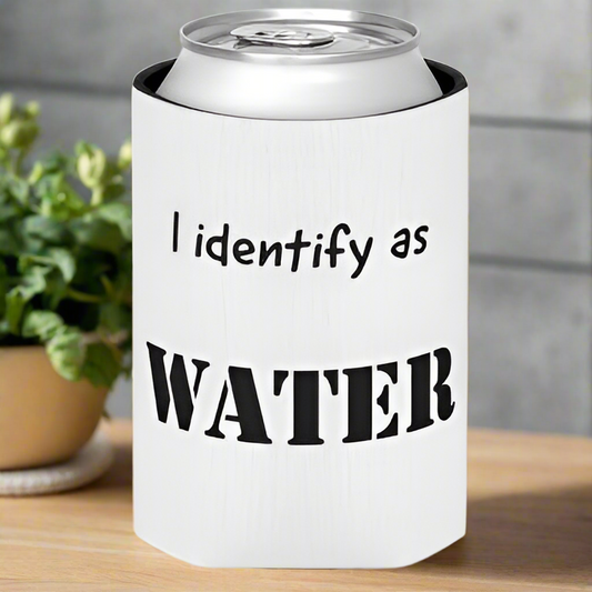 A canned drink in a Kreative Kreationz 6-Pack Customizable Koozie labeled "I identify as WATER" sits on a table, with a small potted plant in the background.