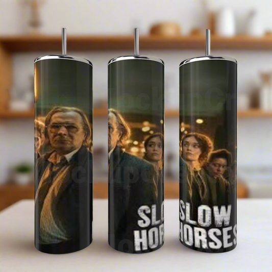 The Kreative Kreationz Slow Horses 20oz Stainless Steel Tumbler features eco-friendly construction and printed TV series characters, including a man in glasses and suit, with the bold show title—perfect for Slow Horses fans.