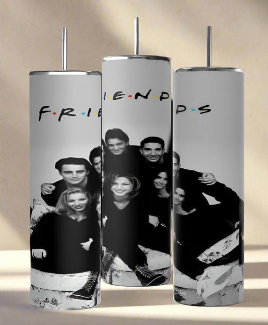 Kreative Kreationz's Friends B&W 20oz tumbler features black and white images of smiling friends. "FRIENDS" shines above them in colorful dotted letters, adding a luxurious eco-friendly charm to your drinkware collection.