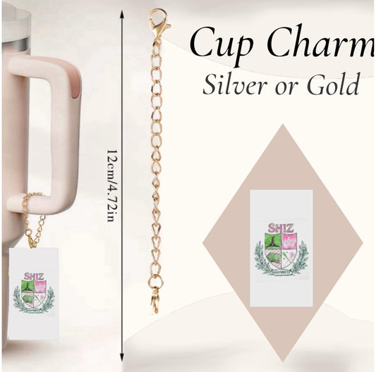 The Kreative Kreationz Wicked Shitz University Charm Dangle is a personalized cup accessory in silver or gold, featuring a "SHIZ" crest charm (12 cm/4.72 in) with a clip to attach to mug handles.