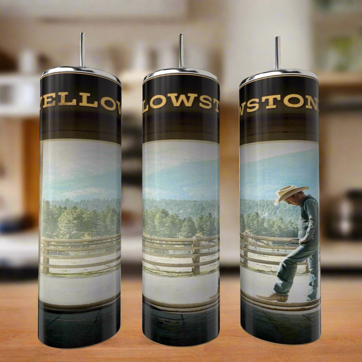 Three Kreative Kreationz John Dutton Yellowstone 20oz Tumblers with straws, each showcasing a cowboy and mountain design, are arranged on a kitchen counter.