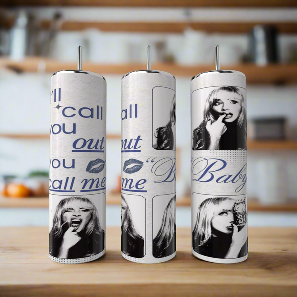 The Kreative Kreationz “I’ll call you out | Sabrina Carpenter 20oz Tumbler” is displayed next to three vertical paper towel rolls with blue and black pop art, featuring a woman's face and phrases like "call you out" and "Baby.
