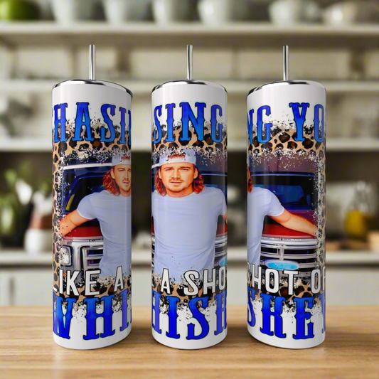 Three eco-friendly Morgan Wallen 20oz Tumblers by Kreative Kreationz feature a man with long hair and a cap by a truck, bold blue "Chasing you like a shot of whiskey" text, and include reusable straws.