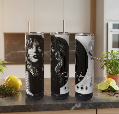 Three cylindrical drinks with 'Taylor Swift' branding on a kitchen counter.