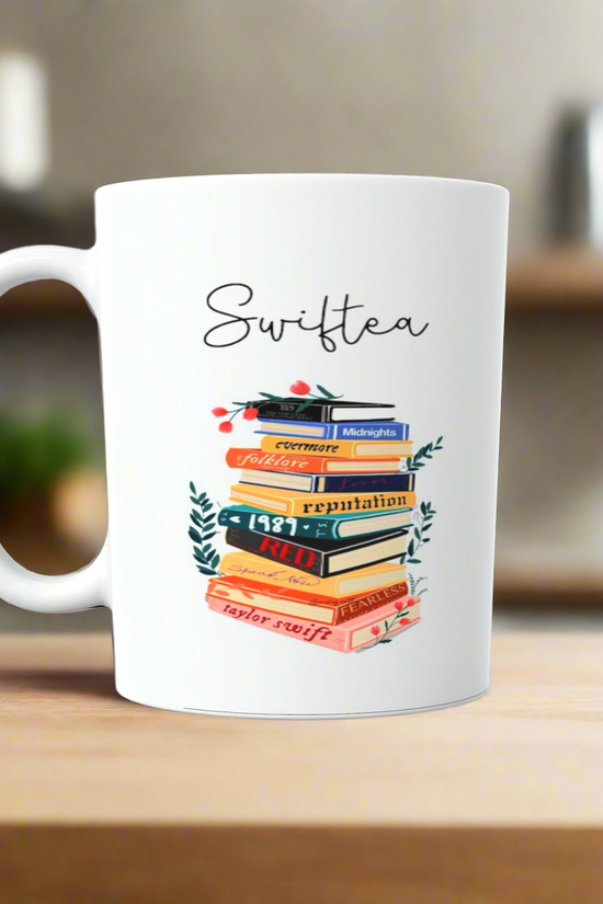 A white ceramic mug by Kreative Kreationz sits on a wooden surface featuring 