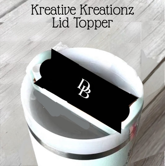 The D&B Stanley Lid Plate/Topper by Kreative Kreationz is a black lid topper labeled "KB" in white text, shown on a light wooden surface. The display features the Kreative Kreationz name above the accessory.