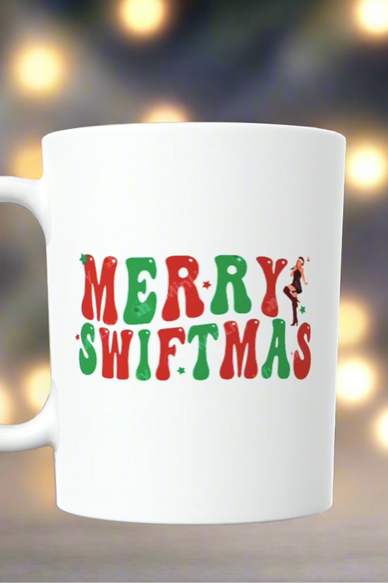 This merry season, enjoy your beverage in the Merry Swiftmas Taylor Swift Ceramic Mug by Kreative Kreationz, a white ceramic mug adorned with the text 