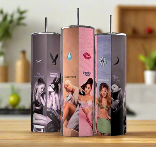 Three Kreative Kreationz Ariana Grande Albums 20oz stainless steel tumblers, each featuring different album or era themes, stand on a wooden surface in a modern kitchen with a softly blurred background for an eco-friendly touch.