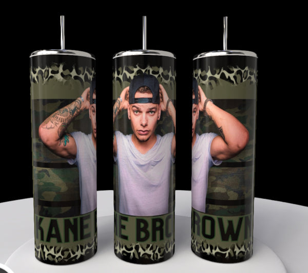 The Kane Brown 20oz Tumblers by Kreative Kreationz showcase a camo pattern with an image of a person in a white shirt and backward cap, hands near head. Kane Brown's name is elegantly displayed at the bottom, adding style to these unique tumblers.