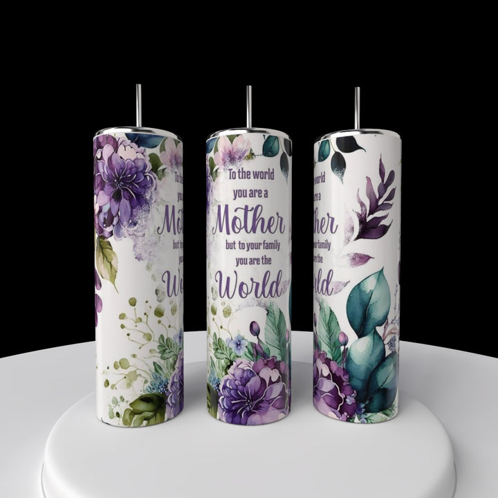 Three Kreative Kreationz Mom 20oz Tumblers with straws sit on a white platform, each featuring purple and green botanical designs and the message: "To the world you are a Mother, but to your family you are the World.