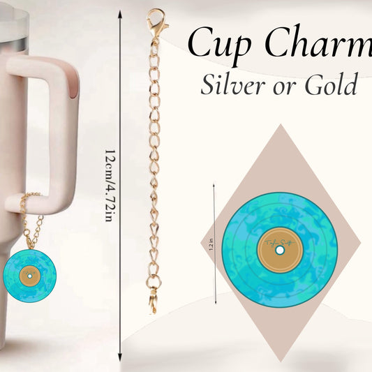 The Taylor Swift Vinyl Charm Dangle by Kreative Kreationz hangs from a 12 cm waterproof gold chain on a mug handle. A close-up shows the unique cup accessory, available in silver or gold.