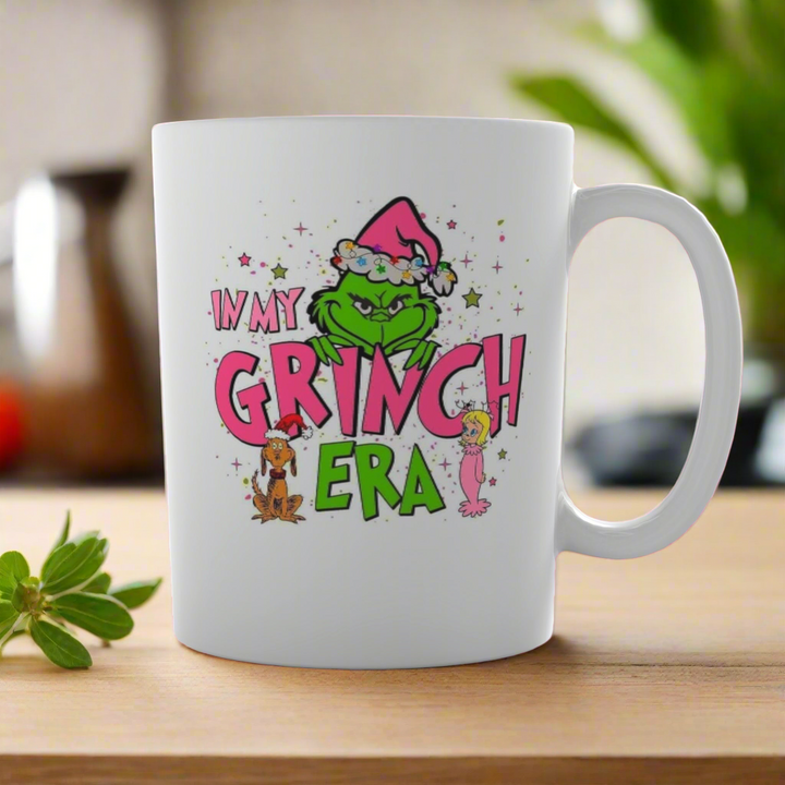 The Grinch Era Ceramic Mug from Kreative Kreationz features the Grinch in a Santa hat with “I’m in my Grinch era” and festive accents, perfect for fans of the classic Dr. Seuss story.