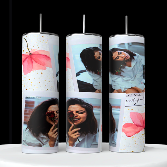 The stylish and sustainable Selena Gomez Coral Collage 20oz Stainless Steel Tumblers by Kreative Kreationz feature eco-friendly designs: a woman with a flower, abstract pink blooms, and gold speckles on a black background with silver lids.