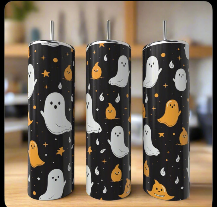 The Kreative Kreationz Ghosts 20oz Tumblers feature cute white and orange ghost designs with stars and sparkles on black backgrounds. Each stainless steel tumbler is shown indoors against a blurred backdrop.