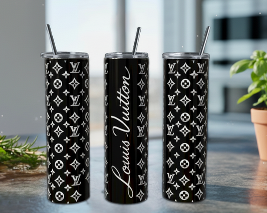 Three black tumblers with white patterns and branding on a reflective surface.
