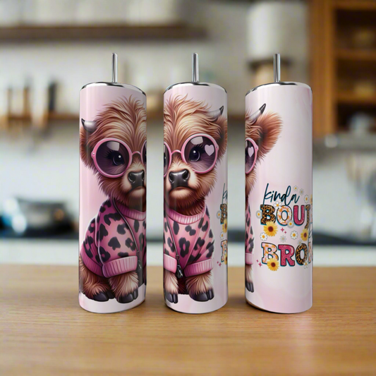 Three tall 20oz stainless steel tumblers from Kreative Kreationz's Kinda Boujee But Broke Cow Collection showcase a cute cow in pink glasses and leopard print, one with "kinda boujee bro," styled on a wooden kitchen surface—eco-friendly and fun!.