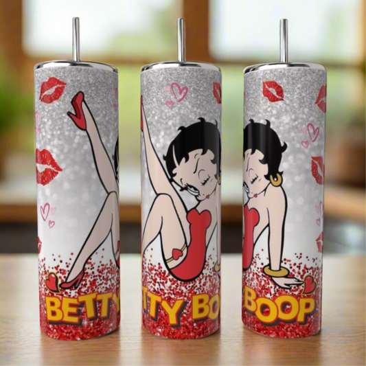 The Kreative Kreationz Boop 20oz Skinny Tumbler features Betty Boop in her red dress with red lips and a glittery background. Each stainless steel tumbler is reusable and showcases the bold "BETTY BOOP" text.
