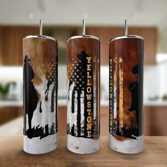 Three Kreative Kreationz Yellowstone 20oz Tumblers sit on a kitchen counter, each made of eco-friendly stainless steel and decorated with cowboy, bear, and horse silhouettes over a rustic American flag and cowhide design.