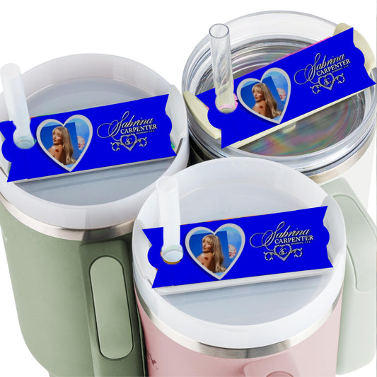 Three tumblers with lids and straws feature the Kreative Kreationz Sabrina Carpenter Stanley lid Topper, which displays a heart-shaped photo of Sabrina Carpenter, her name, and musical notes on a decorative background.