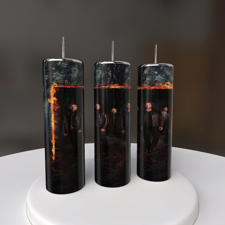 Three cylindrical Supernatural 20oz Skinny Tumblers by Kreative Kreationz, with fiery orange portals, frame men in a dark forest. Arranged side by side on a white base, they make a striking display for fans and collectors.