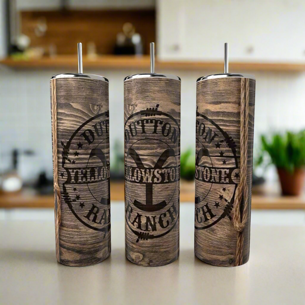 Three Kreative Kreationz Dutton Ranch 20oz Tumblers with faux wood grain and metal straws are lined up on a kitchen counter, each featuring the "Yellowstone Dutton Ranch" logo against a blurred backdrop.
