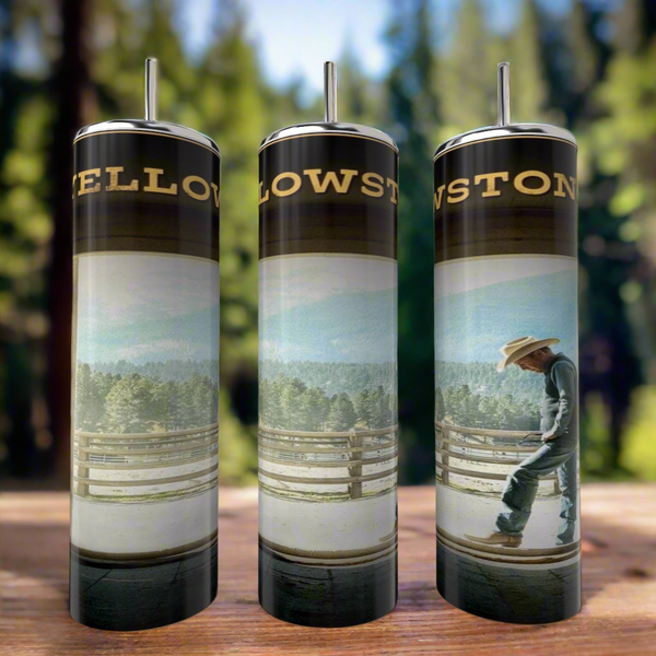 Three Kreative Kreationz John Dutton Yellowstone 20oz tumblers with metal straws are displayed on wood. Each stainless steel tumbler shows a cowboy by a fence with a scenic forest and mountain background.