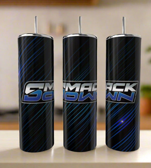 Three tall Kreative Kreationz WWF Smackdown 20oz tumblers with straws are shown side by side, featuring a black background, blue diagonal streaks, and a bold “SMACKDOWN” logo—stylish reusable drinkware for fans.