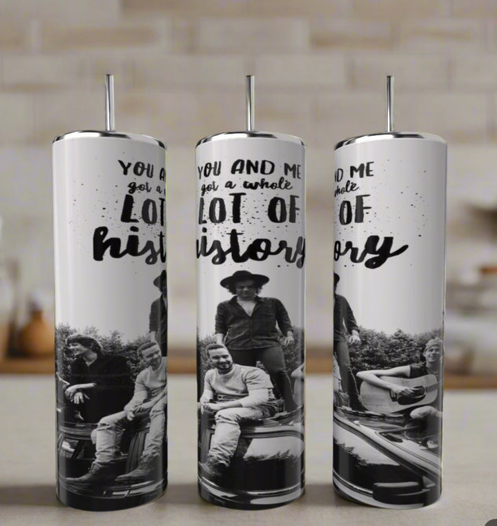 The Kreative Kreationz One Direction You & Me Got a Lot Of History 20oz tumbler features a black-and-white photo of four people on a car with bold, artistic lettering—perfect as a unique sublimated gift. Comes with straw.