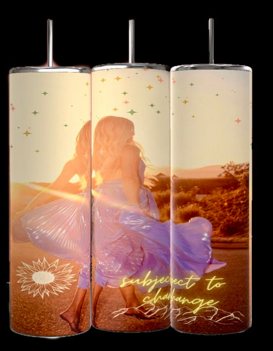 The Subject To Change Kelsey Ballerini 20oz Tumbler by Kreative Kreationz features three tall, cylindrical, stainless steel tumblers adorned with a luxury design of a woman in a flowing dress, sunflowers, stars, and the words "subject to change" at the base.