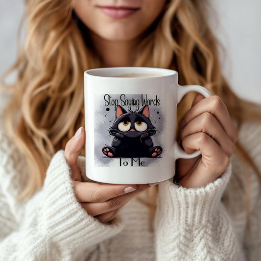 A woman in a cozy white sweater holds Kreative Kreationz’s Dont Talk To Me Mug, featuring a cartoon black cat and the phrase "Stop Saying Words To Me"—a dishwasher-safe gift.
