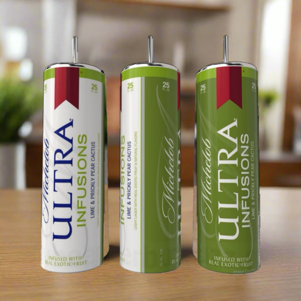 Three cans of Michelob Ultra Infusions Lime & Prickly Pear Cactus beer rest on a wooden surface beside a sleek 20oz Silver Stainless Steel Tumbler by Kreative Kreationz, perfect for enjoying your drink in style.