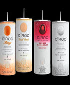 Two cans of Kreative Kreationz Ciroc 20oz Tumbler with 3D Lid Topper are shown on a wooden surface, reminiscent of travel tumblers. The left can is Red Berry flavor, topped with ice and a cherry. The right can is Vodka Snap Frost flavor, topped with ice and a lemon slice. Both cans feature product information and branding.