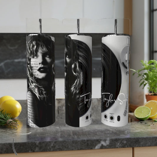 Three cylindrical containers with a design on a kitchen counter with lemons and a plant.